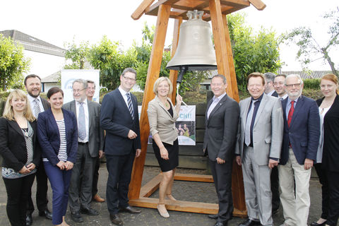 INTERKULTUR guests and team standing in front of World Choir Games Peace Bell