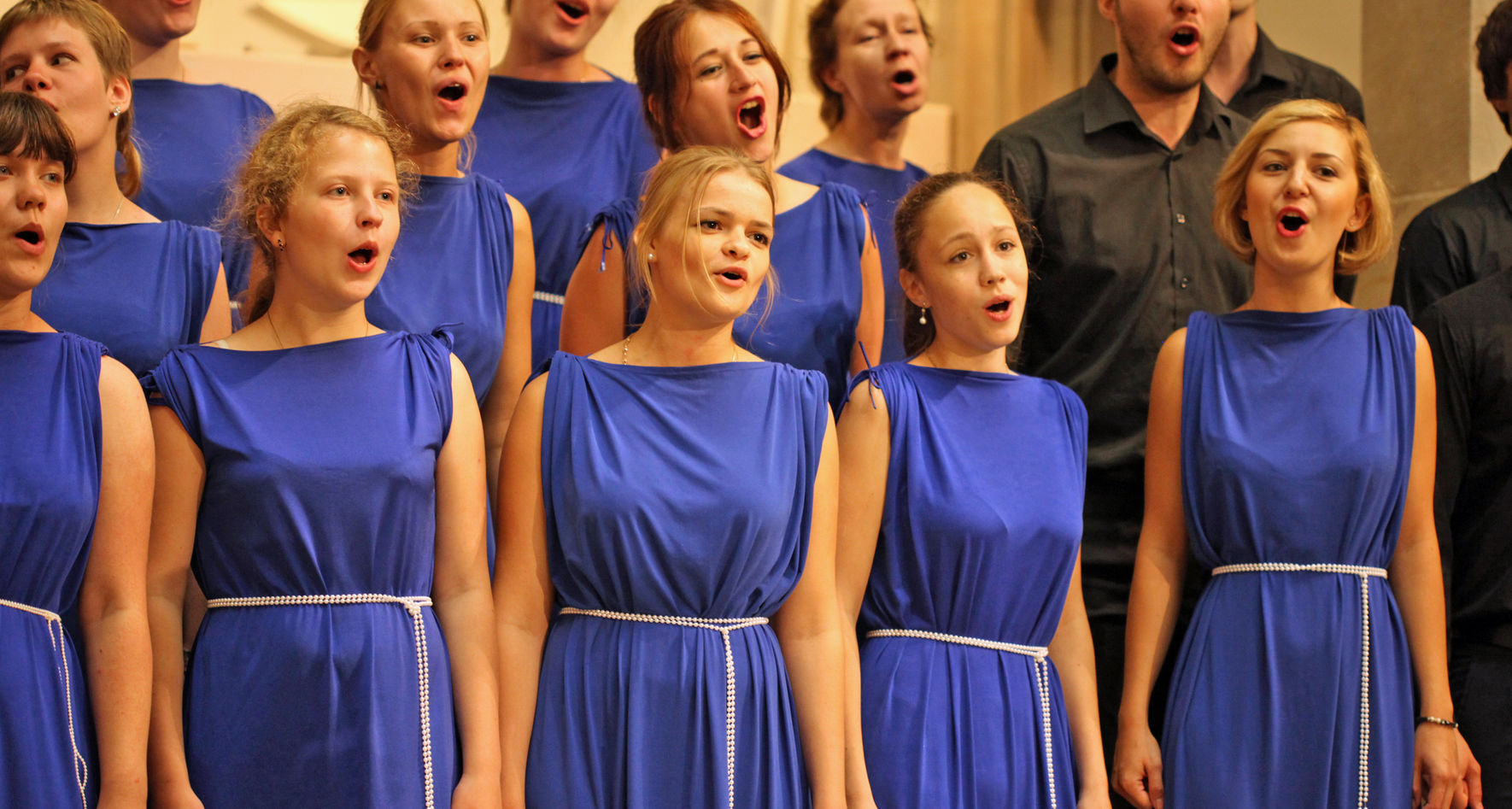 Singing choir in blue dresses